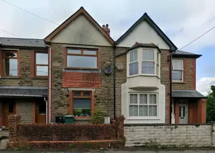 Stone-fronted semi-detached house with a bay window in Cardiff